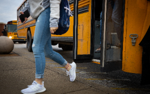  Girl student walking off bus
